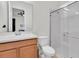 Bright bathroom featuring a single sink vanity and a walk-in shower with glass doors at 3850 Bonfire Dr, Odessa, FL 33556