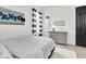 Well lit bedroom with a dresser, decor and gray paneled bed at 3850 Bonfire Dr, Odessa, FL 33556