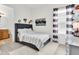 Bedroom with name art, gray paneled bed and striped curtains at 3850 Bonfire Dr, Odessa, FL 33556