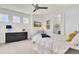 Bright bedroom featuring a comfortable bed, three windows, and a dark-wood dresser at 3850 Bonfire Dr, Odessa, FL 33556