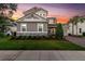 Beautiful two-story house at sunset with stone accents, a manicured lawn, and brick driveway at 3850 Bonfire Dr, Odessa, FL 33556