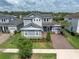 Charming two-story home with a well-manicured lawn, brick driveway, and inviting front porch at 3850 Bonfire Dr, Odessa, FL 33556