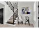 Inviting foyer with staircase, tasteful artwork, and natural light from a window at 3850 Bonfire Dr, Odessa, FL 33556