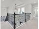 Hallway with a decorative chandelier, carpeted floors, and a staircase at 3850 Bonfire Dr, Odessa, FL 33556