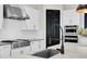 This modern kitchen features stainless steel appliances, sleek white cabinets, and a spacious island with a black faucet at 3850 Bonfire Dr, Odessa, FL 33556