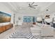 Spacious living room with tray ceilings, a modern ceiling fan, and sliding glass doors leading to the lanai at 3850 Bonfire Dr, Odessa, FL 33556