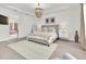 Bright main bedroom with chandelier, ensuite bath, and hardwood floors at 3850 Bonfire Dr, Odessa, FL 33556