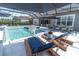 Stunning pool with lounge chairs and a basketball hoop, great for outdoor fun and relaxation at 3850 Bonfire Dr, Odessa, FL 33556