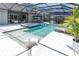 Exterior view of a modern pool with spa, umbrellas, and outdoor seating area at 3850 Bonfire Dr, Odessa, FL 33556