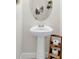 Powder room with a pedestal sink, modern faucet and white walls at 3850 Bonfire Dr, Odessa, FL 33556
