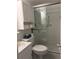 Well-lit bathroom features a toilet, a glass door shower, and a white vanity with storage at 4152 56Th N Way # 513, Kenneth City, FL 33709