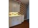 Kitchen features white cabinets and floral wallpaper accents at 4152 56Th N Way # 513, Kenneth City, FL 33709