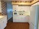 Well-equipped kitchen features a refrigerator, stove, oven and white cabinets at 4152 56Th N Way # 513, Kenneth City, FL 33709
