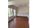 Bright living room featuring wood-look flooring, a large window, and a built-in storage unit at 4152 56Th N Way # 513, Kenneth City, FL 33709