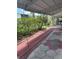 Relaxing covered patio surrounded by lush greenery and a comfortable seating area at 4152 56Th N Way # 513, Kenneth City, FL 33709