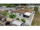 Aerial of backyard with patio, partial enclosure, landscaping, privacy fence, and yard equipment at 4902 Murray Hill Drive, Tampa, FL 33615