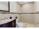 Updated bathroom with a tiled walk-in shower and a stylish vanity with marble countertop at 4902 Murray Hill Drive, Tampa, FL 33615