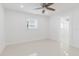 Bright bedroom with neutral paint and floors features window and ceiling fan at 4902 Murray Hill Drive, Tampa, FL 33615
