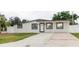 Charming single-story home featuring a well-maintained lawn and inviting covered entry at 4902 Murray Hill Drive, Tampa, FL 33615