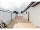 Exterior view of side yard leading to the In-Law suite, white exterior, bordered by fence at 4902 Murray Hill Drive, Tampa, FL 33615