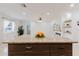 Close-up of kitchen island with modern lighting and a view into the stylish living space at 4902 Murray Hill Drive, Tampa, FL 33615
