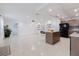 Bright living room with fireplace, large island, and tile floors at 4902 Murray Hill Drive, Tampa, FL 33615