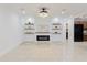 Open-concept living space featuring fireplace and a modern kitchen with black appliances at 4902 Murray Hill Drive, Tampa, FL 33615