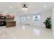 Bright living room with modern lighting, tile flooring, and open layout to the kitchen at 4902 Murray Hill Drive, Tampa, FL 33615