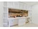 Built-in shelves surround the desk and modern wood backsplash at 4902 Murray Hill Drive, Tampa, FL 33615