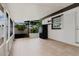 Spacious patio area with tile flooring, refrigerator, and a view of the outdoors at 4902 Murray Hill Drive, Tampa, FL 33615