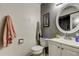 Cozy bathroom featuring a stylish sink, mirror, and charming patterned floor at 4908 Rockledge Cir, Tampa, FL 33624