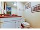 Bathroom with white cabinets, granite countertop, framed art, and decorative mirror at 4908 Rockledge Cir, Tampa, FL 33624