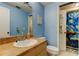 A clean bathroom with a sink, toilet, and a shower with a colorful curtain at 4908 Rockledge Cir, Tampa, FL 33624