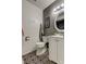 Stylish bathroom featuring a sink, toilet, and unique patterned floor at 4908 Rockledge Cir, Tampa, FL 33624