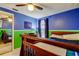A bedroom featuring blue and green walls, a wooden bed frame, and a mirrored closet at 4908 Rockledge Cir, Tampa, FL 33624