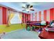 A vibrant bedroom with striped walls, a bunk bed, and a ceiling fan at 4908 Rockledge Cir, Tampa, FL 33624