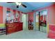 Bright bedroom featuring unique stripe walls, closet with mirror doors, and ceiling fan at 4908 Rockledge Cir, Tampa, FL 33624