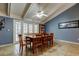 Well-lit dining area with tile flooring, vaulted ceilings, a ceiling fan and a table with chairs at 4908 Rockledge Cir, Tampa, FL 33624