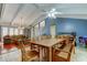 Open concept living and dining area featuring beautiful exposed beams and wood accents at 4908 Rockledge Cir, Tampa, FL 33624