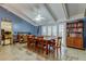 Bright dining room featuring a ceiling fan, tile flooring, and double doors to the outdoor area at 4908 Rockledge Cir, Tampa, FL 33624