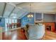 Cozy living room with vaulted ceilings, a fireplace, and tile and wood flooring at 4908 Rockledge Cir, Tampa, FL 33624