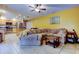 An open-concept living room and kitchen featuring light wood cabinets, an island, and a large couch at 4908 Rockledge Cir, Tampa, FL 33624