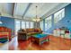 Open living room with a vaulted ceiling, fireplace, hardwood floors, and natural lighting at 4908 Rockledge Cir, Tampa, FL 33624
