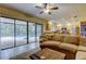 A well-lit living room featuring a plush couch, coffee table and sliding glass doors leading to the pool at 4908 Rockledge Cir, Tampa, FL 33624