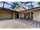 A screened in patio with a graphic outdoor rug and patio furniture at 4908 Rockledge Cir, Tampa, FL 33624