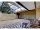 Screened-in patio with gravel flooring, outdoor rug, and patio furniture at 4908 Rockledge Cir, Tampa, FL 33624