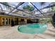 Private swimming pool with screened enclosure, alongside the home's exterior and outdoor entertainment area at 4908 Rockledge Cir, Tampa, FL 33624