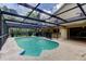 Inviting in-ground pool with a screened enclosure, complemented by a spacious deck and outdoor space at 4908 Rockledge Cir, Tampa, FL 33624