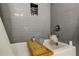 This tub features gray tile, a shelf, and a wooden tub tray at 4908 Rockledge Cir, Tampa, FL 33624