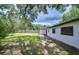 View of home exterior and backyard including luscious trees and landscaping at 4911 Country Aire Ln, Tampa, FL 33624